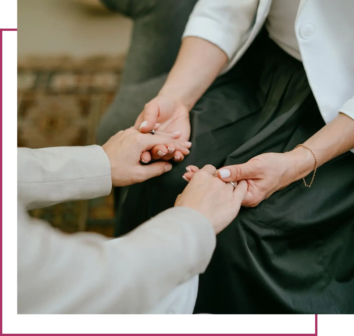 Two people holding hands in comfort.