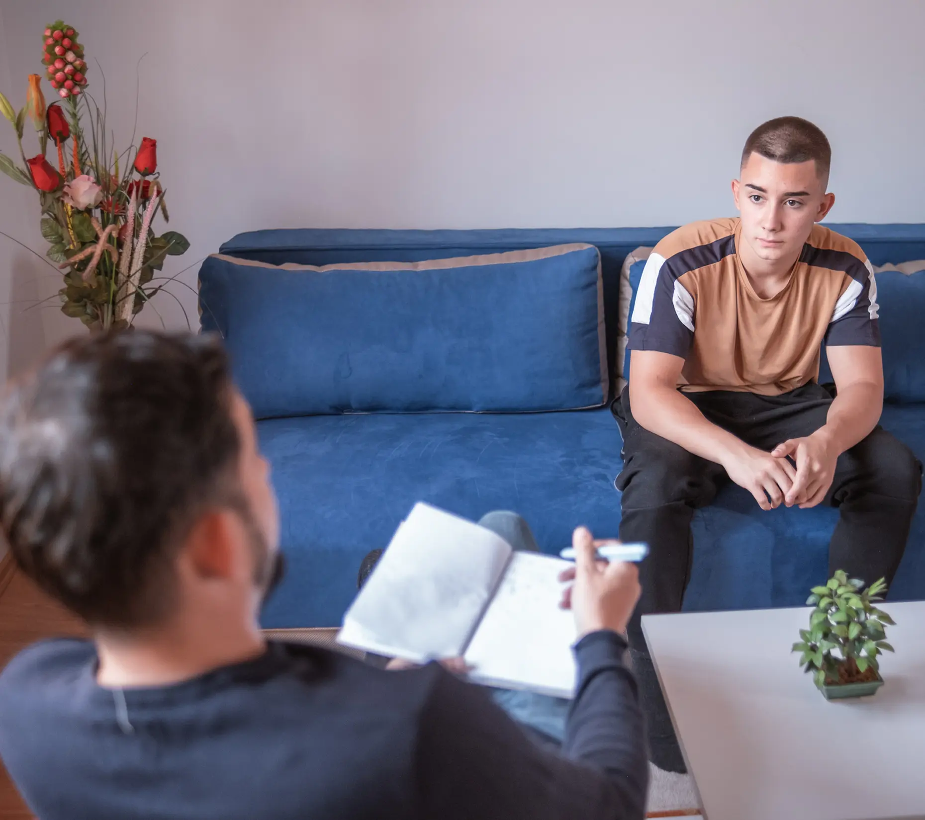 Two people having a serious conversation indoors.